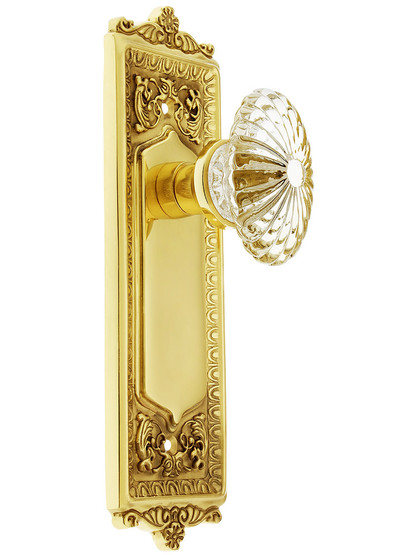 Egg and Dart Style Door Set with Oval Fluted Crystal Glass Knobs without Keyhole in Unlacquered Brass.